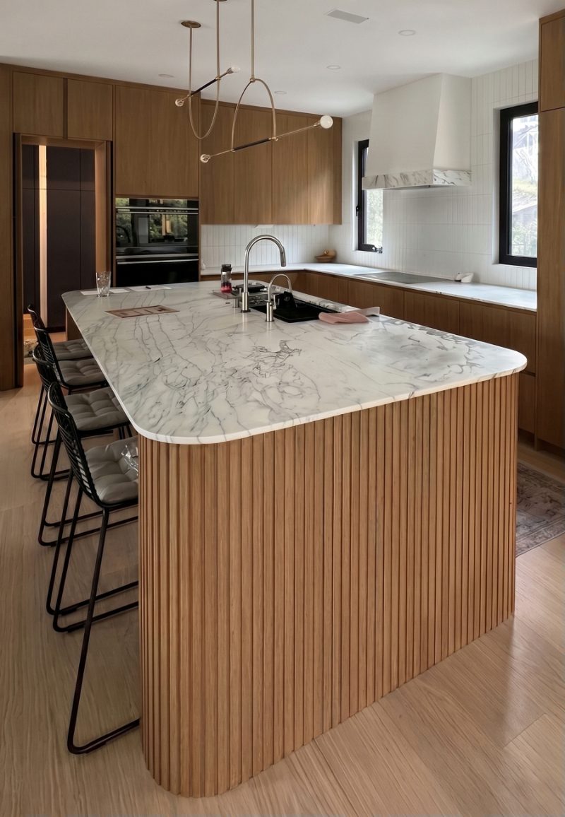 Curved island with fluted panels