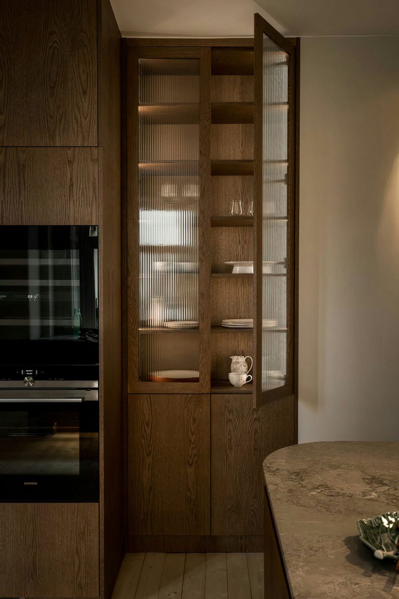 Wooden pantry with fluted glass